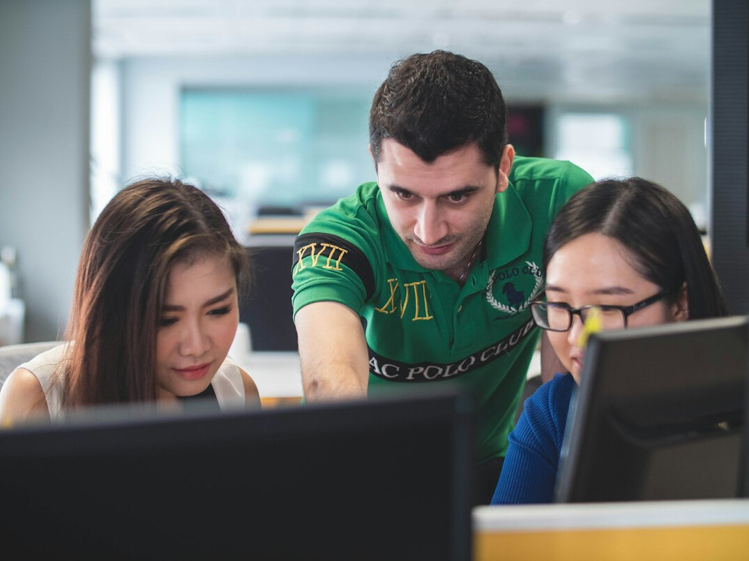 students coding together in class