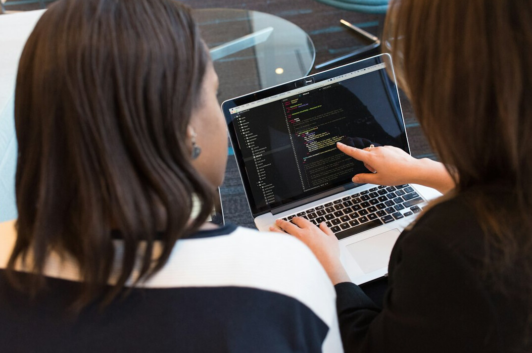 teacher helping student with code