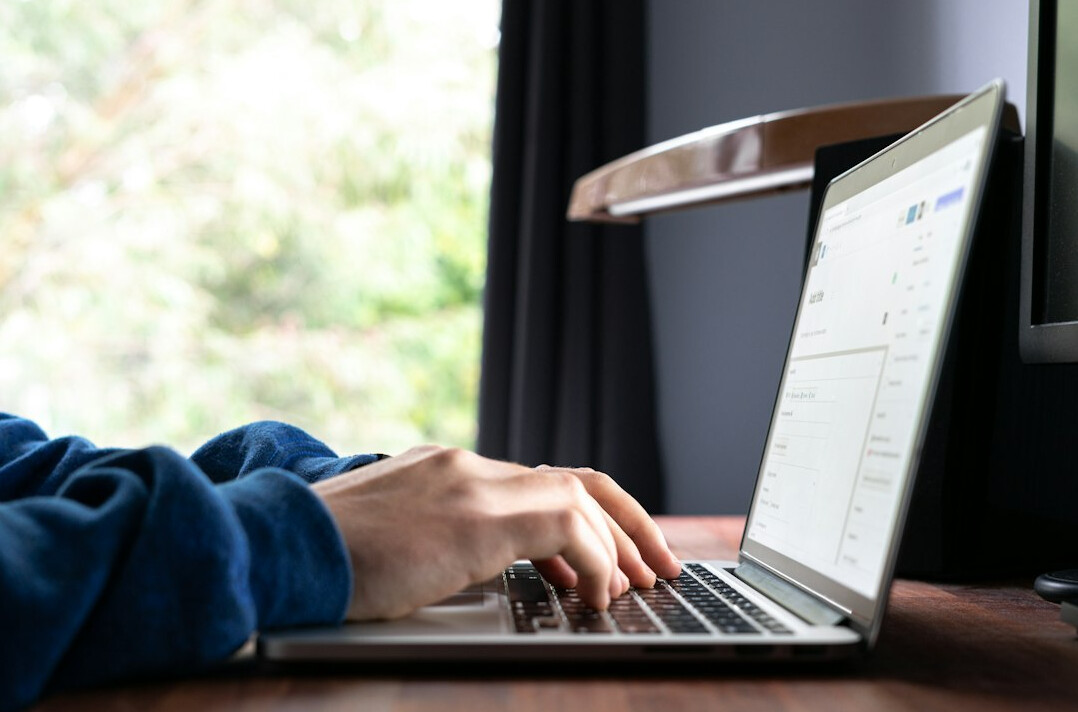 person coding on laptop
